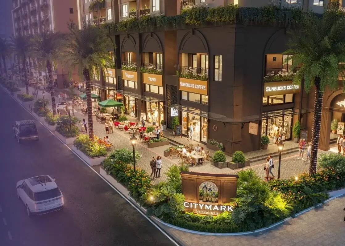 Góc shophouse khối đế lúc chiều tối, phố và cây xanh